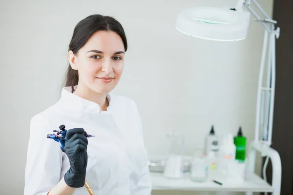 Dövme makinesi cımbız ile kadın güzellik uzmanı