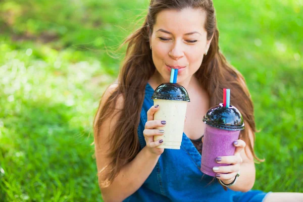 Juicy fresh cold healthy delicious smoothie milkshake young woman drink