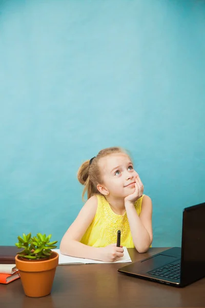 Happy elementary student girl homeschooling on laptop online by internet. — Stock Photo, Image