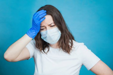 Antiviral tıbbi maskeli genç kadın depresyonda, üzgün ve endişeli hissediyor..