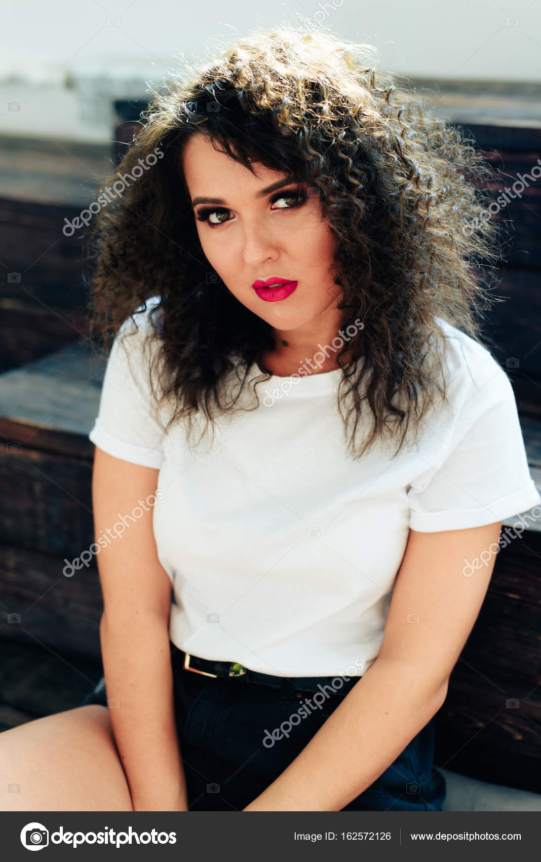Curly Beautiful Brunette Girl With Short Hair In A White