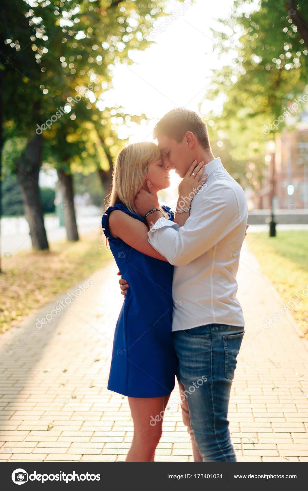 Beautiful Couple In Love With A Woman Walking In A Park On A Bench