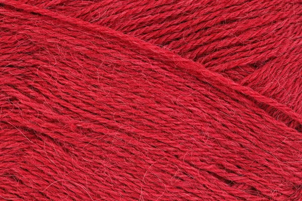 Ein Nahbild rot aus Wollgarn zum Stricken. Hintergrund. — Stockfoto