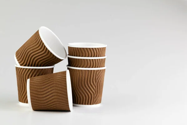 Einweg-Kaffeetasse aus Papier auf grauem Hintergrund. Getränkepaket. — Stockfoto