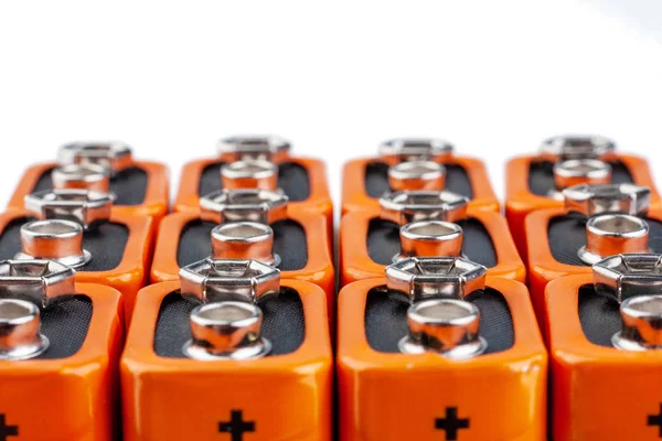 Many Orange Batteries Stand Several Rows Isolated White Background — Stockfoto
