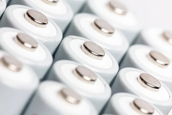 AA batteries are close to each other. Close-up of white batteries on a white background. Battery technology.