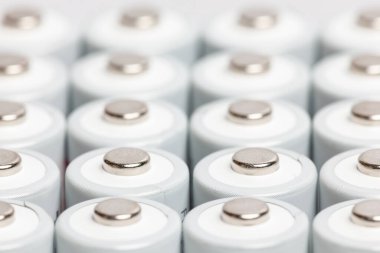 AA batteries are close to each other. Close-up of white batteries on a white background. Battery technology.
