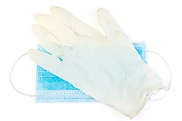 Medical masks and rubber gloves on a white background. Corona virus. Healthcare and medical concept. Close up view of medical protection of face and hands . mask textile filter