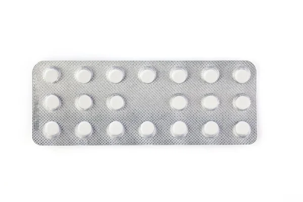 Pile of tablets in blister packaging. Pharmaceutical industry. Pharmacy products. Health care. New blister with pills isolated on a white background.