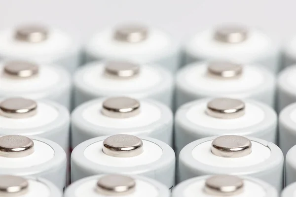 AA batteries are close to each other. Close-up of white batteries on a white background. Battery technology.