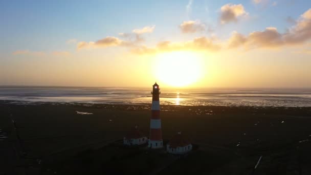 Lighthouse at sunset, aerial view, moving away — 비디오