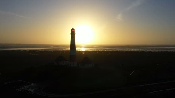 Lighthouse at sunset, aerial view, silhouette — Stock Video