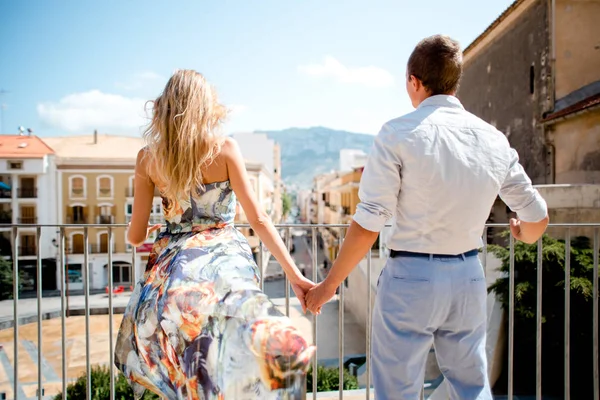 Couple walking in the city of Denia, Spain on summer day