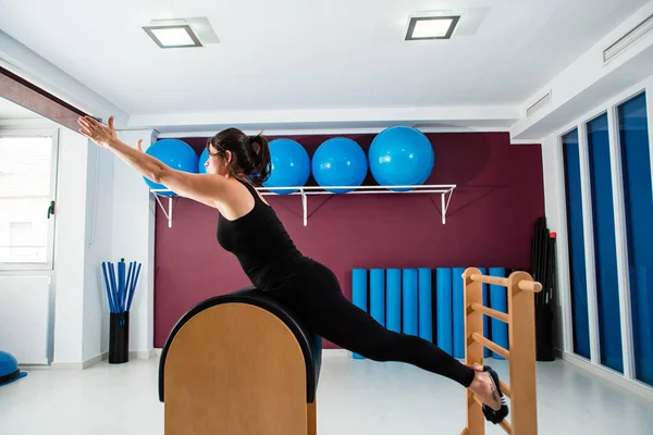 Ung Passar Kvinna Stretching Pilates Stege Fat Andra Pilates Utrustning — Stockfoto