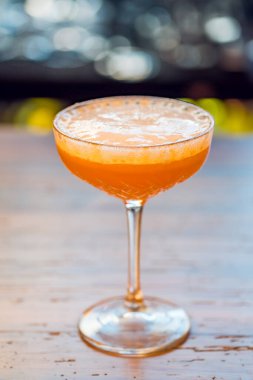 Close-up glass of cosmopolitan cocktail at bar background