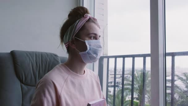 Young Thoughtful Woman Medical Protective Mask Looking Out Window Writing — Stock Video