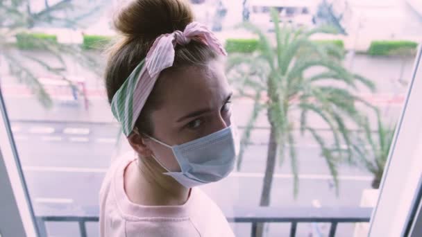 Close Young Sad Woman Medical Protective Mask Looking Out Window — Stock Video