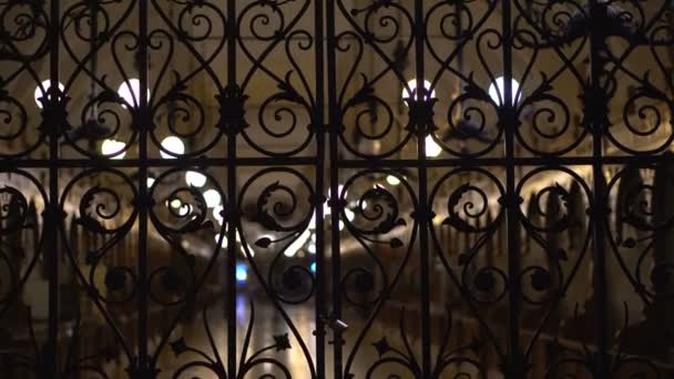 Cloth Hall behind a locked iron gate night background — Stock Video