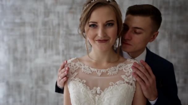 Brudgummen kramar bruden i en loft-interiör — Stockvideo