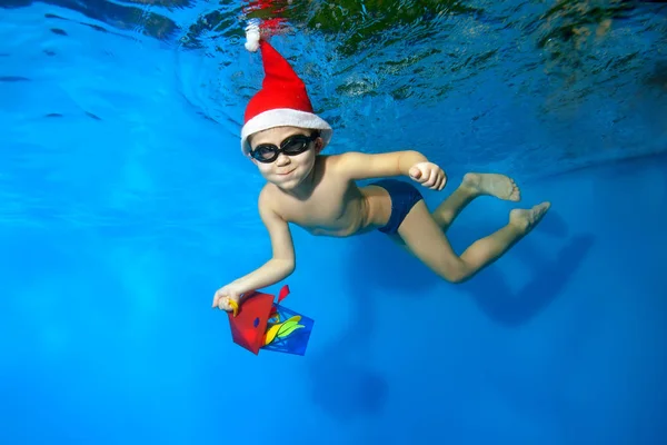 Little Boy Cap Santa Claus Swims Underwater Gift Hand Blue — Stock Photo, Image