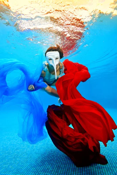 Girl White Mask Swims Underwater Red Blue Fabrics Background Sunset — Stock Photo, Image
