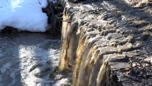 Dirty water pouring waterfall in the spring river. Close up. 4K, 25 fps — Stock Video