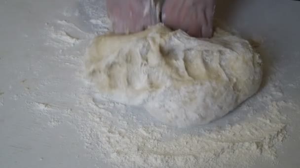 Girl kneads dough at home on a white table. — Stock Video