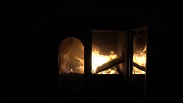 La puerta de cristal de la chimenea se abre y un fuego brillante es visible. Símbolo. Concepto. Primer plano. 4k . — Vídeo de stock