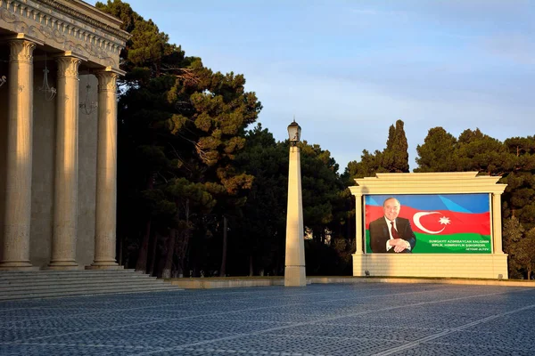 Haydar Aliyev Azerbaycan bayrağı posteri önünde