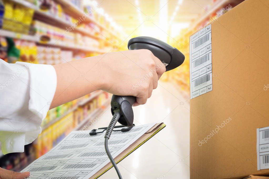 Supermarket Female cashier use code scanner, customer checkout