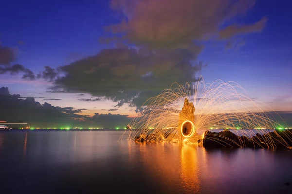 Amazing Fire dancing steel wool  in the twilight.