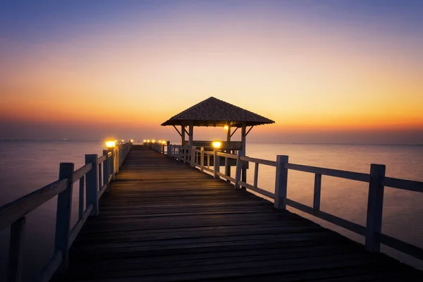 Wood bridge to the sea at sunset. Stock Picture