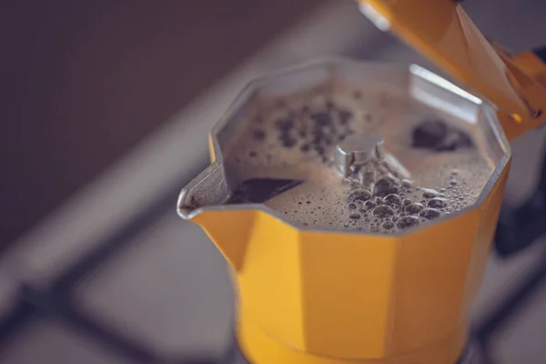 The process of brewing coffee in a coffee maker dot on a dark background Toning