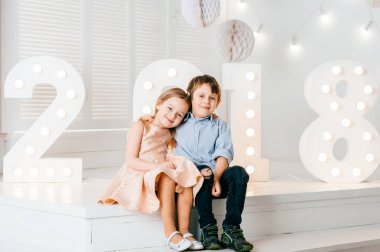 Çocukları seviyorum. Yakışıklı çocuk ve güzel küçük Prenses birbirlerine sarılma. 2018 yeni yıl. Yeni yaer süslemeler güzel duygusal samimi çocuk. Kış tatilleri kutluyor. Noel ruh hali.