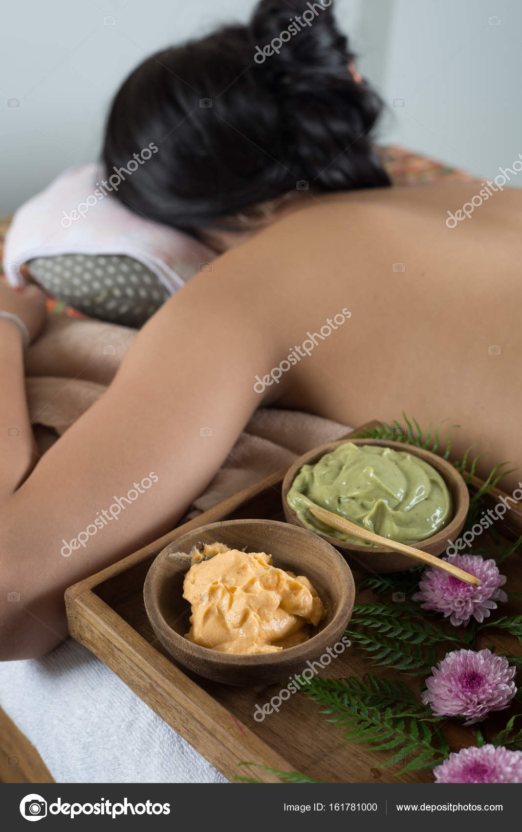 Massage series: Asian woman lying bareback on massage bed in spa Stock  Photo by ©kunksy.gmail.com 161781000