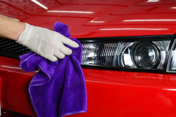 Car detailing series: Closeup of hand cleaning red car — Stock Photo, Image