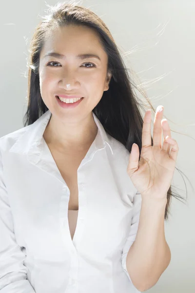 Beauty series: Happy Asian woman applying moisturizer — Stock Photo, Image