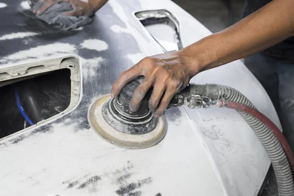 Автоматический ремонт кузова: крупный план механического шлифования капота автомобиля — стоковое фото