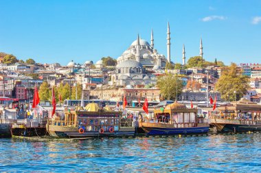 ISTANBUL, TURKEY -  October 9th, 2019: View to Eminonu pier and Suleymaniye mosque across Bay of Golden Horn on sunny morning