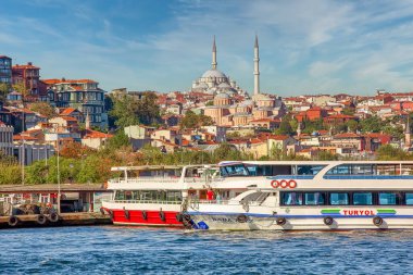 ISTANBUL, TURKEY -  October 9th, 2019: View to Eminonu pier and Suleymaniye mosque across Bay of Golden Horn on sunny morning