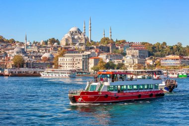 ISTANBUL, TURKEY -  October 9th, 2019: View to Eminonu pier and Suleymaniye mosque across Bay of Golden Horn on sunny morning