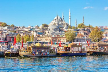 ISTANBUL, TURKEY -  October 9th, 2019: View to Eminonu pier and Suleymaniye mosque across Bay of Golden Horn on sunny morning