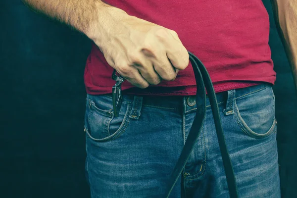 A strict father holds the girdle, the concept of violence — Stock Photo, Image