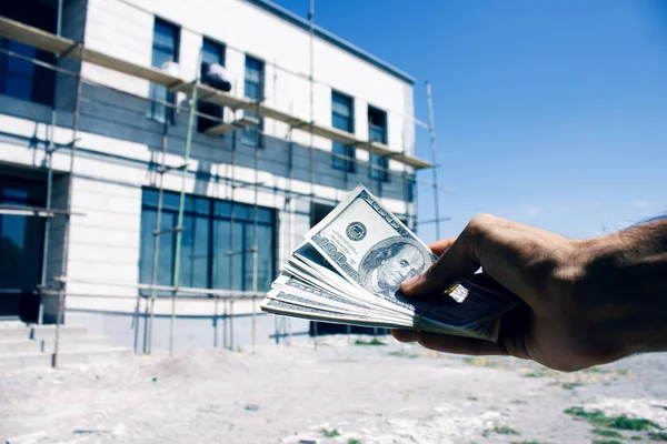 Man gives money for building a house Stock Picture