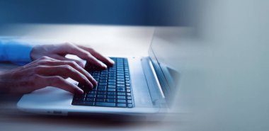 Genç adam bilgisayarla çalışıyor.