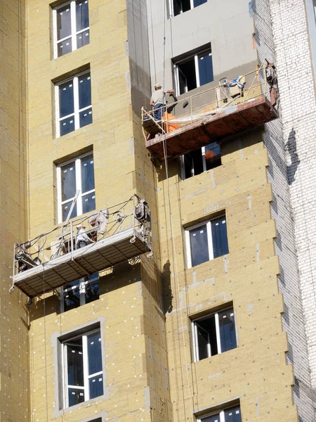 Teamwork. Putty. Technological stage of building a multistory building.