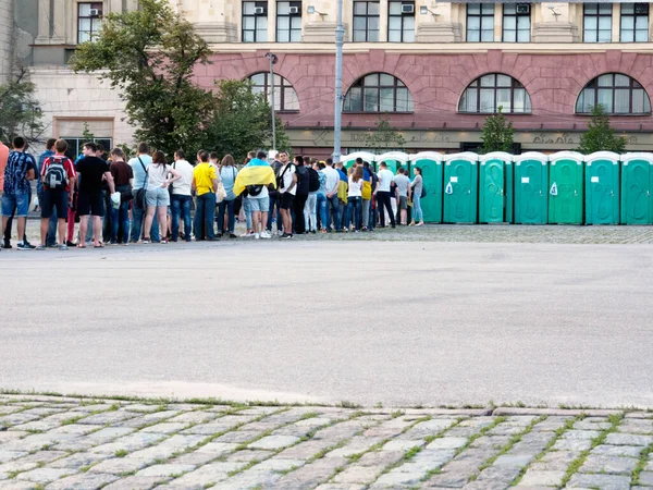 Kharkov,Ukraine-June 16,2016: The queue of fans to the toilet stalls in fan-zone during the break of the match Ukraine-Northern Ireland (0-2).An example of spatial planning and process administration.