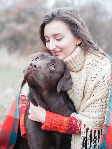 girl with dog, chocolate labrador