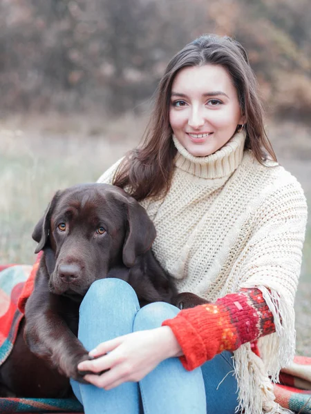 girl with dog, chocolate labrador