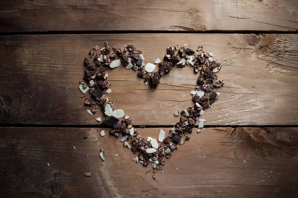Granola heart on wooden background — Stock Photo, Image